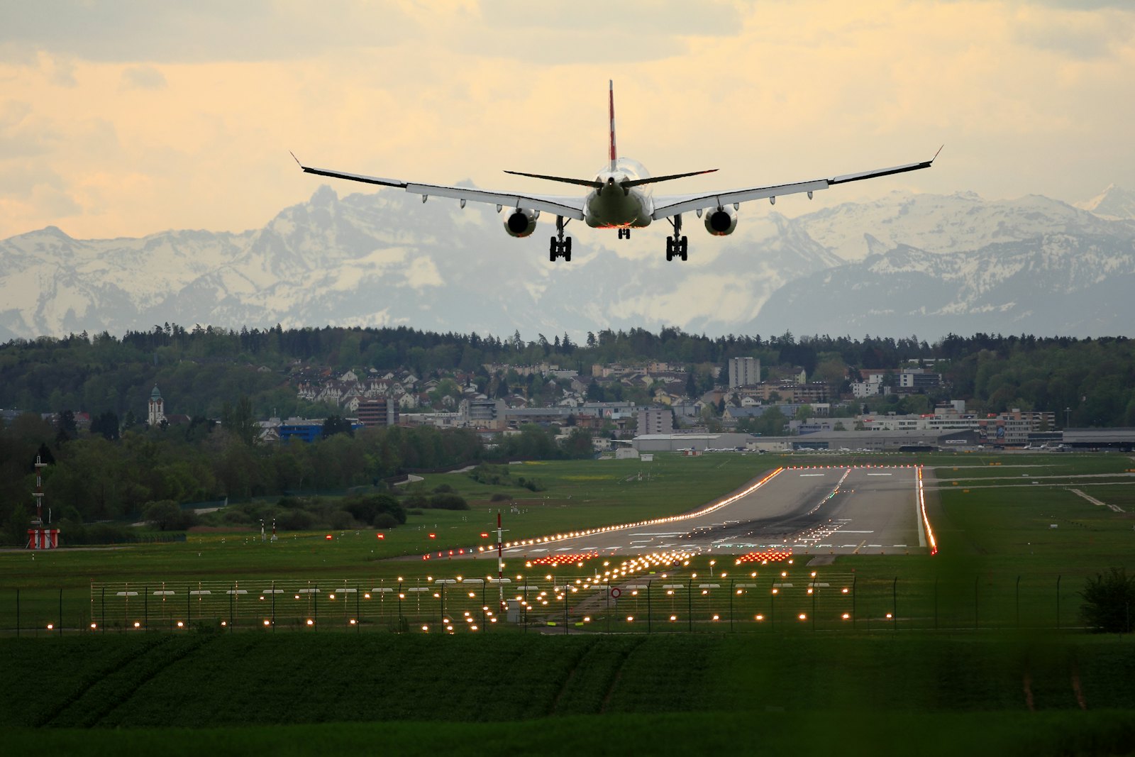 An aircraft on final approach above runway lights