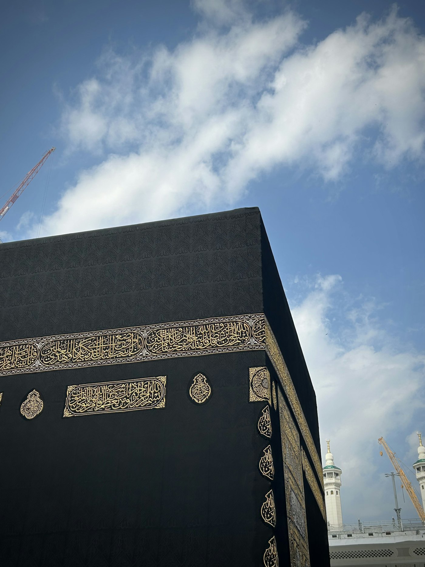 The Kaaba draped in its kiswah against an open sky